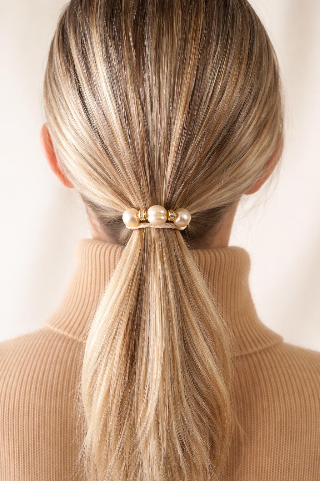 Blonde hair in pearl jeweled hair tie with CZ and blonde cord